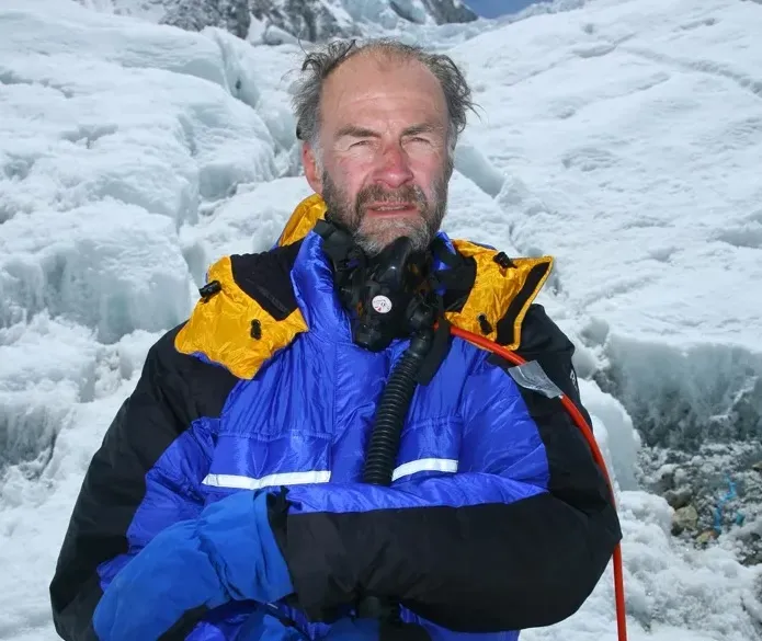 Sir Ranulph Fiennes wearing blue and yellow polar expedition gear on glacial ice.